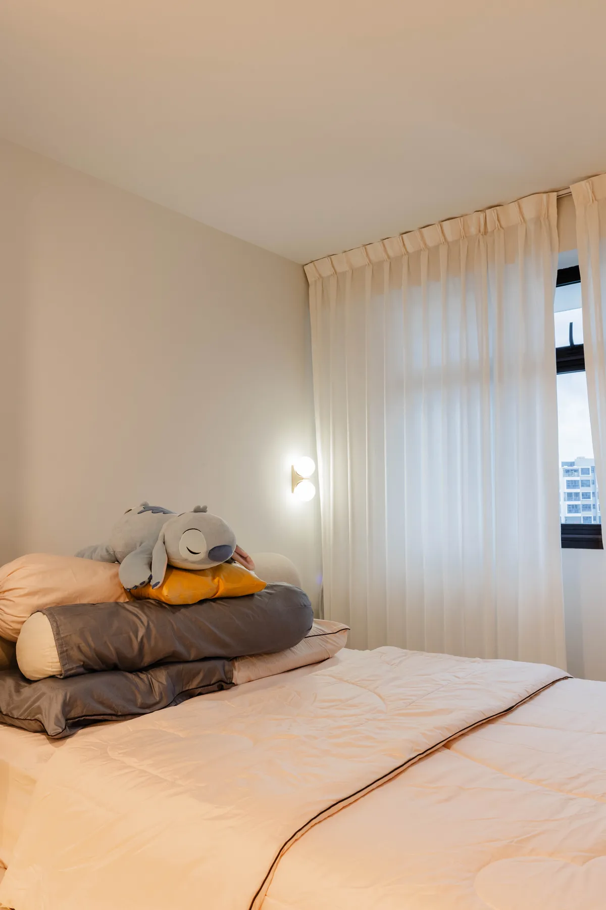 Bedroom window with sheer curtains at Fernvale St