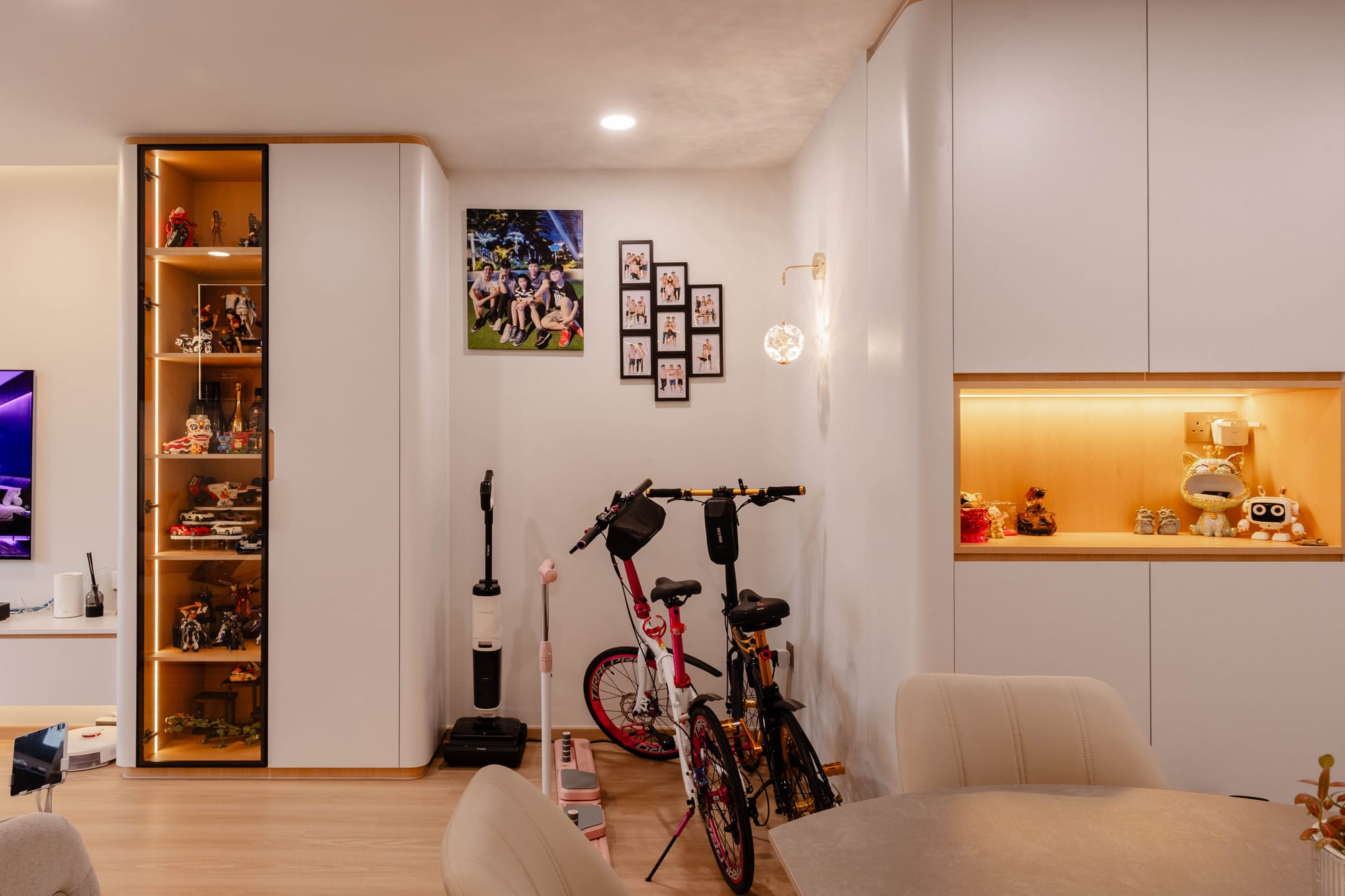 Entry niche at Fernvale St with warm backlit display shelves around the Lego collection