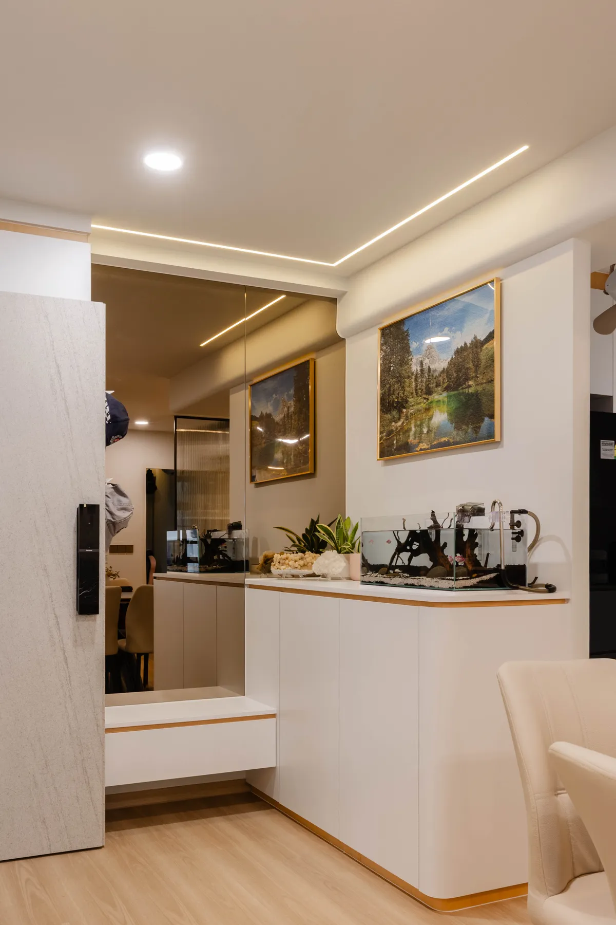 Hallway view into the kitchen with framed artwork at Fernvale St