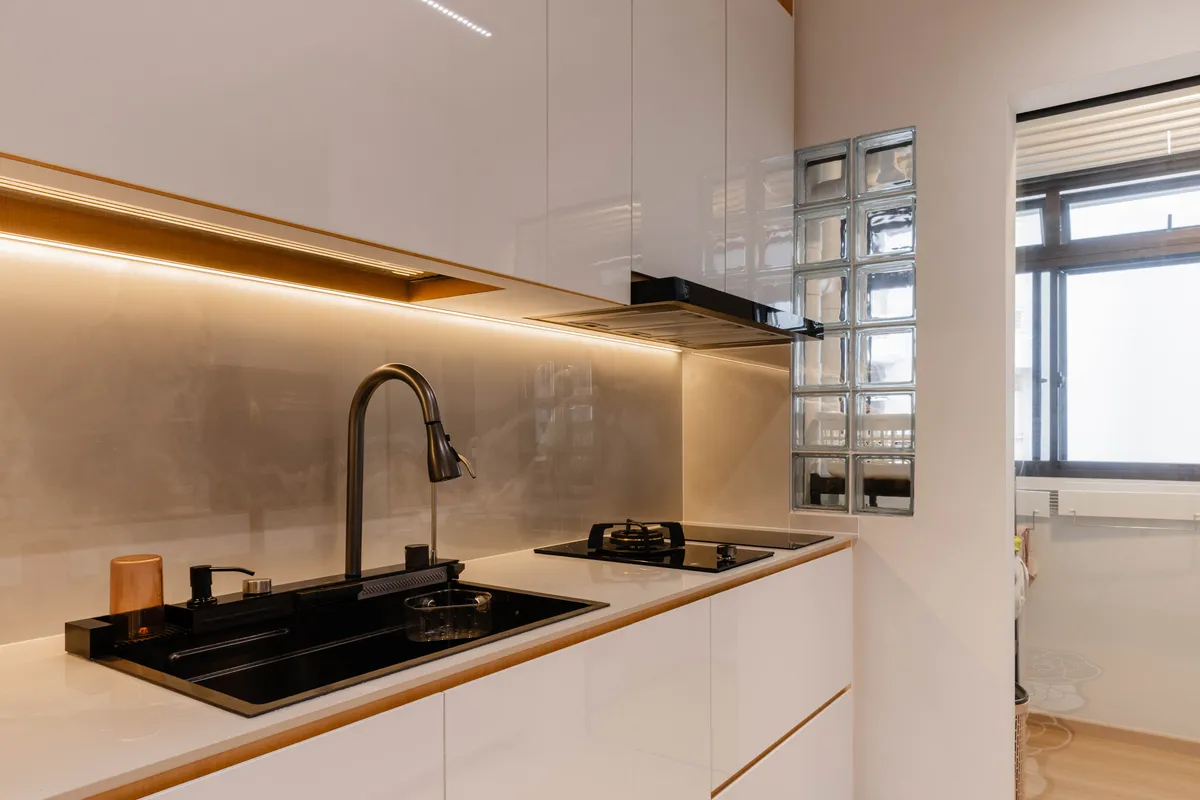 Rebuilt white kitchen with warm under-cabinet lighting